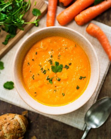 A bowl of Carrot and Coriander Soup with a sprinkle of coriander over the top. Image by Jaz Kitchen