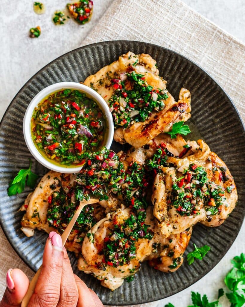 Our chimichurri with chicken is bright, vibrant and fresh, with tender chicken thighs and a beautiful sauce you will not be able to get enough of! Recipe by Jaz Kitchen