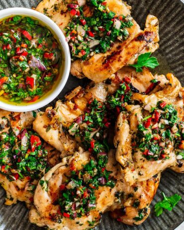 Our chimichurri with chicken is bright, vibrant and fresh, with tender chicken thighs and a beautiful sauce you will not be able to get enough of! Recipe by Jaz Kitchen
