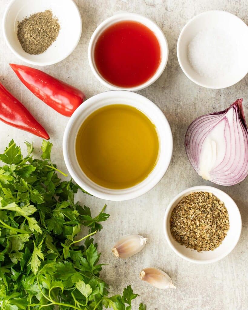 Ingredients required: parsley, red chillies, red onion, garlic, olive oil, red wine vinegar, oregano, salt and pepper. Recipe by Jaz Kitchen