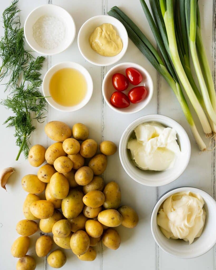 Ingredients required: new potatoes, olive oil, yogurt, mayonnaise, garlic, apple cider vinegar, dijon mustard, spring onions, cherry tomatoes, dill and salt. Recipe by jaz kitchen
