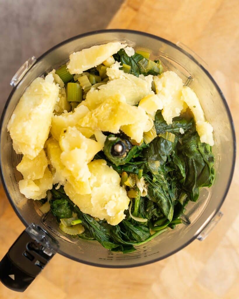 Place all the cooked greens into a blender with the potato...