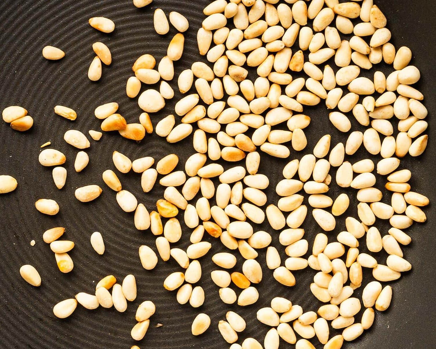 lightly toasted pine nuts for pesto sauce. Image by Jaz Kitchen